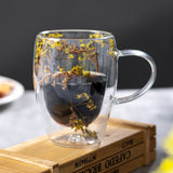 "Double-wall insulated glass coffee mug – heat-resistant, high-temperature safe, stylish dried flower design, elegant handle cup perfect for lattes, home, or office use."