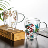 "Double-wall insulated glass coffee mug – heat-resistant, high-temperature safe, stylish dried flower design, elegant handle cup perfect for lattes, home, or office use."